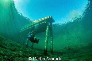 Divers in Attersee (Austria) under a jetty by Martin Schrack 